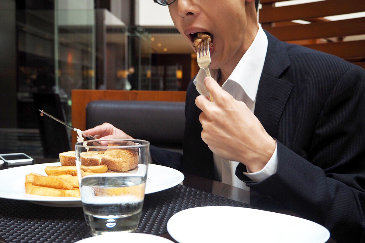 メインディッシュを食べるKさん